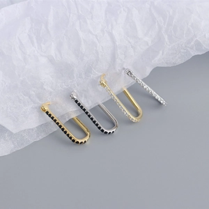 Detail of four geometric S925 sterling silver earrings with zircon in U-shape design