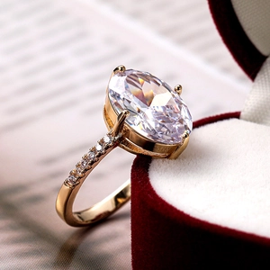Macro shot of marquise zirconia ring with gold plating in a red velvet jewelry box