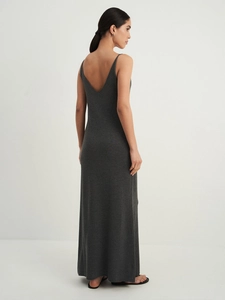 Detail of dark grey knit maxi dress showing slim straps and elegant deep V-back design