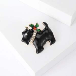 Macro detail of enamel Scottish Terrier brooch with festive holly and rhinestone collar