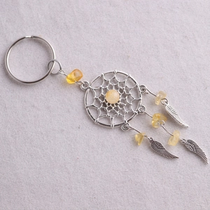 Llavero atrapasueños detallado con plumas plateadas y piedras de cristal amarillo