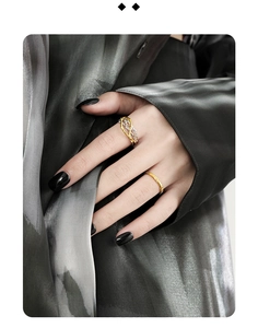 Detail of S925 silver irregular winding thorn rings in gold and silver on a model hand