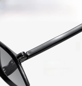 Detailed macro view of durable metal hinges on vintage black square frame sunglasses