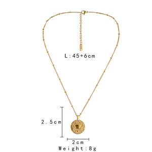 Detail view of golden zodiac necklace showing chain length 45+6cm and coin pendant size