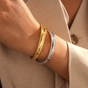 Macro detail of 18k gold plated bangle featuring dual rows of micro-pave zircons
