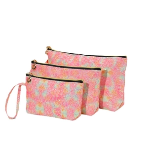 Set of three pink glitter lace makeup bags in various sizes with golden zippers
