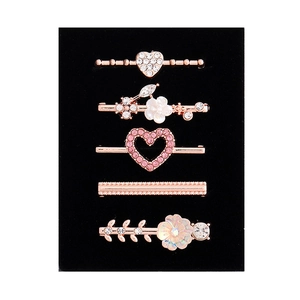 5-piece rose gold watch band charms set with rhinestones and pearls on black background
