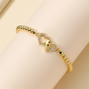 Adjustable golden beaded bracelet with micro-pave zircon hearts and star cutouts