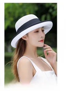 Close-up of contrast black and white straw sun hat with detailed woven texture