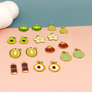 Detail of assorted fruit enamel charms including kiwi pear and avocado for DIY jewelry