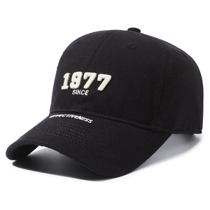 Classic black cotton baseball cap with white 1977 embroidery and curved brim in side view