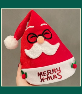 Close-up of Santa Claus plush hat with Merry X-mas embroidery and berry decorations