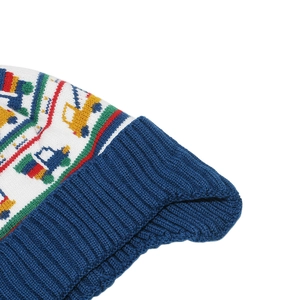 Detail of colorful knitted vehicle jacquard pattern on a white children's winter hat