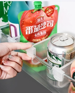 Close-up of adjustable transparent plastic dividers for refrigerator side door organization