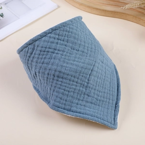 Close-up of blue double-layer gauze baby bib with soft texture and white towel lining