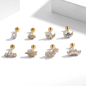 Eight golden G23 titanium labret studs with zircon moon and leaf designs for cartilage
