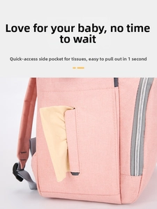 Detail of pink Oxford fabric diaper bag featuring a side pocket for quick tissue access