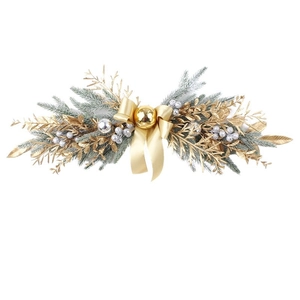 Detailed view of green pine Christmas swag with gold bow and metallic ornaments