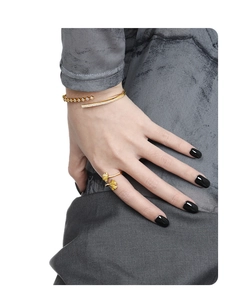 Detail of golden ginkgo leaf ring and open cuff bracelet with white crystals on hand