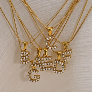 Gold-plated titanium steel snake chain necklaces featuring pearl-encrusted initial pendants