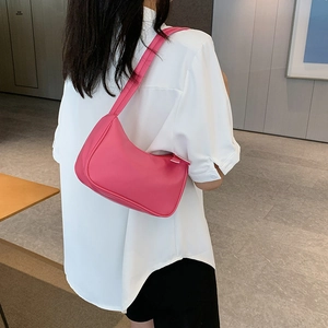 Fashionable rose pink minimalist hobo shoulder bag for women worn by a model in casual style