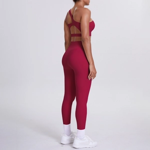Detail of burgundy one-shoulder yoga bra with stylish back cutout and high-waist leggings