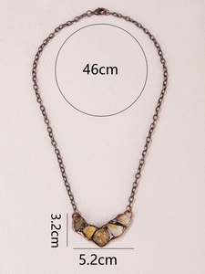 Detail view of vintage bronze necklace with irregular yellow gemstone and size dimensions