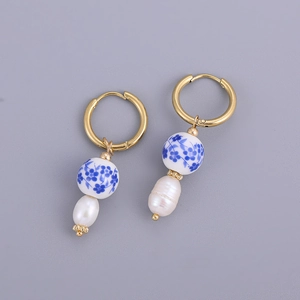 Detail of blue and white porcelain beads with baroque pearls on gold hoop earrings