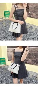 Chic cream white and black handbag with gold hardware shown in lifestyle poses