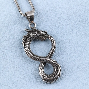 Close-up of infinity dragon pendant in silver steel with textured metal finish