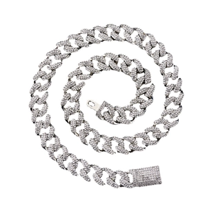 Hip hop silver-toned Cuban link chain necklace with sparkling rhinestones on white background