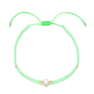 Detail of light green seed bead bracelet with a central freshwater pearl and adjustable cord