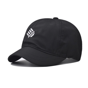 Close-up of quick-dry black outdoor cap with white geometric logo and dual-stitch brim