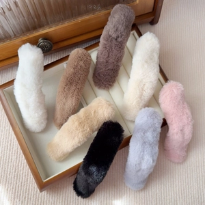 Set of 8 soft plush hair clips in neutral colors displayed in a wooden jewelry box