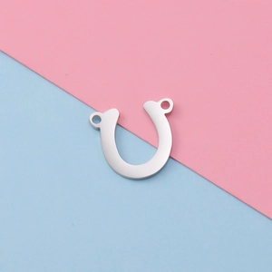 Polished silver stainless steel horseshoe connector for DIY jewelry on colorful background