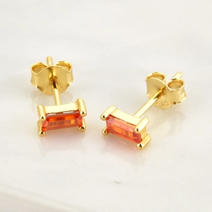 Macro shot of S925 sterling silver earrings with rectangular orange cubic zirconia