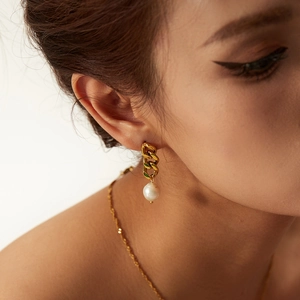Close-up of 18K gold plated Cuban chain earring with Baroque freshwater pearl on model