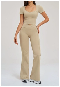 Women's yoga set featuring V-shaped cross waistband pants and slim fit crop top in beige