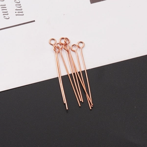 Detailed view of rose gold stainless steel eye pins for DIY jewelry making and beading