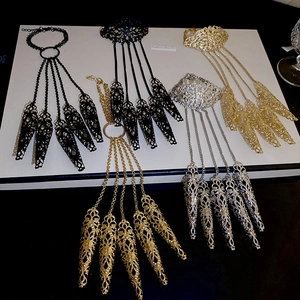 Detail view of hollow flower finger armor rings with wrist bracelet in three colors