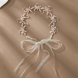 Detailed view of handmade bridal headband with gold leaves, pearls and crystals