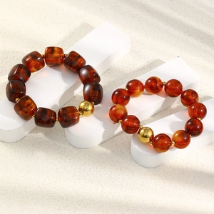 Detailed shot of amber-textured beads and gold beads on vintage style bracelets