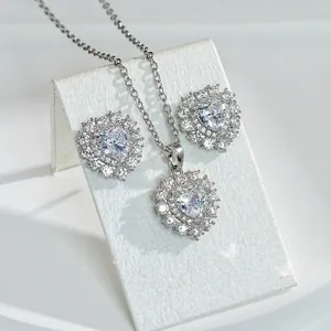 Elegant heart-shaped ruby necklace and earring set with micro-pave crystals in silver