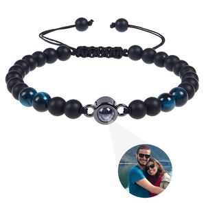 Detail of custom photo projection bracelet with matte black beads and blue tiger eye stone
