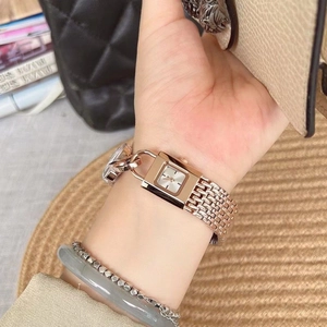 Square rose gold watch with metal chain strap worn on wrist for a minimalist elegant look