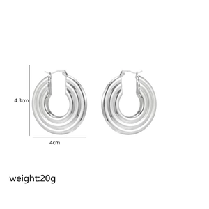 Detail of silver C-shape textured metal earrings, 4.3cm height with layered rib design