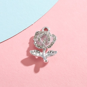 Close-up of silver rose charm pendant with sparkling white cubic zirconia inlay