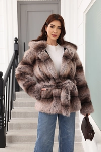 Detailed close-up of tan faux fur jacket texture and plush hood with belted waist design