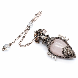 Detail of copper star pendant with rose quartz crystal and beaded metallic chain