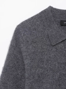 Detailed view of the dark grey polo collar knitwear with fuzzy wool texture and clean seams